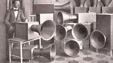 Luigi Russolo and Ugo Piatti standing with multiple Intonarumori noise instruments in a laboratory in Milan, 1913